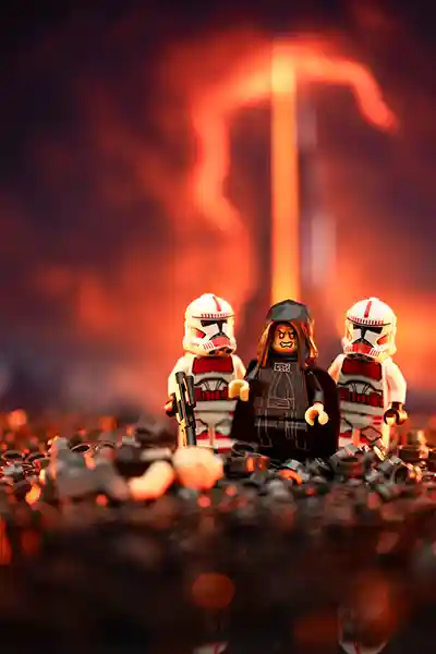 LEGO Emperor Palpatine flanked by two Shock Troopers stands on a scorched battlefield, surrounded by fallen minifigures with a fiery Sith structure glowing in the background.