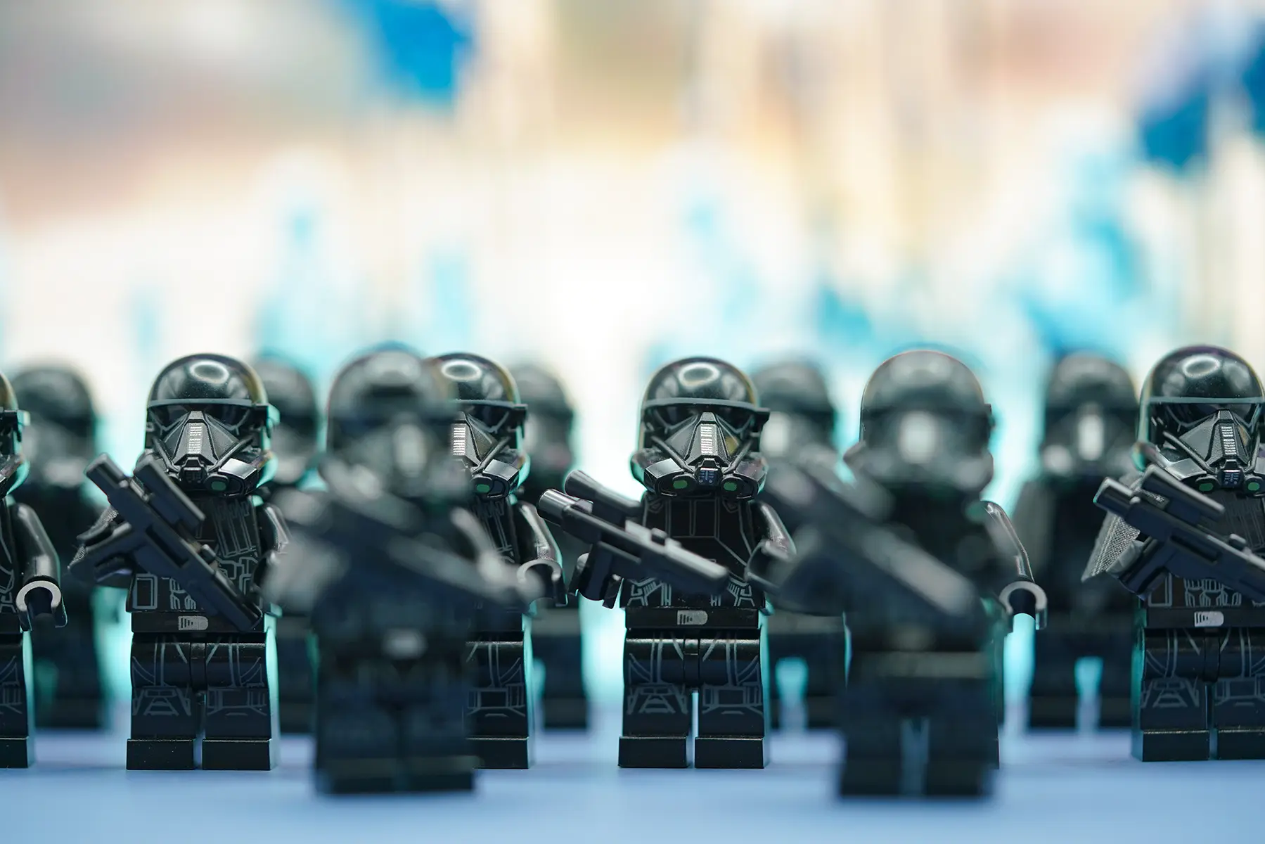 A formation of LEGO Death Trooper minifigures in sharp focus, ready for deployment.