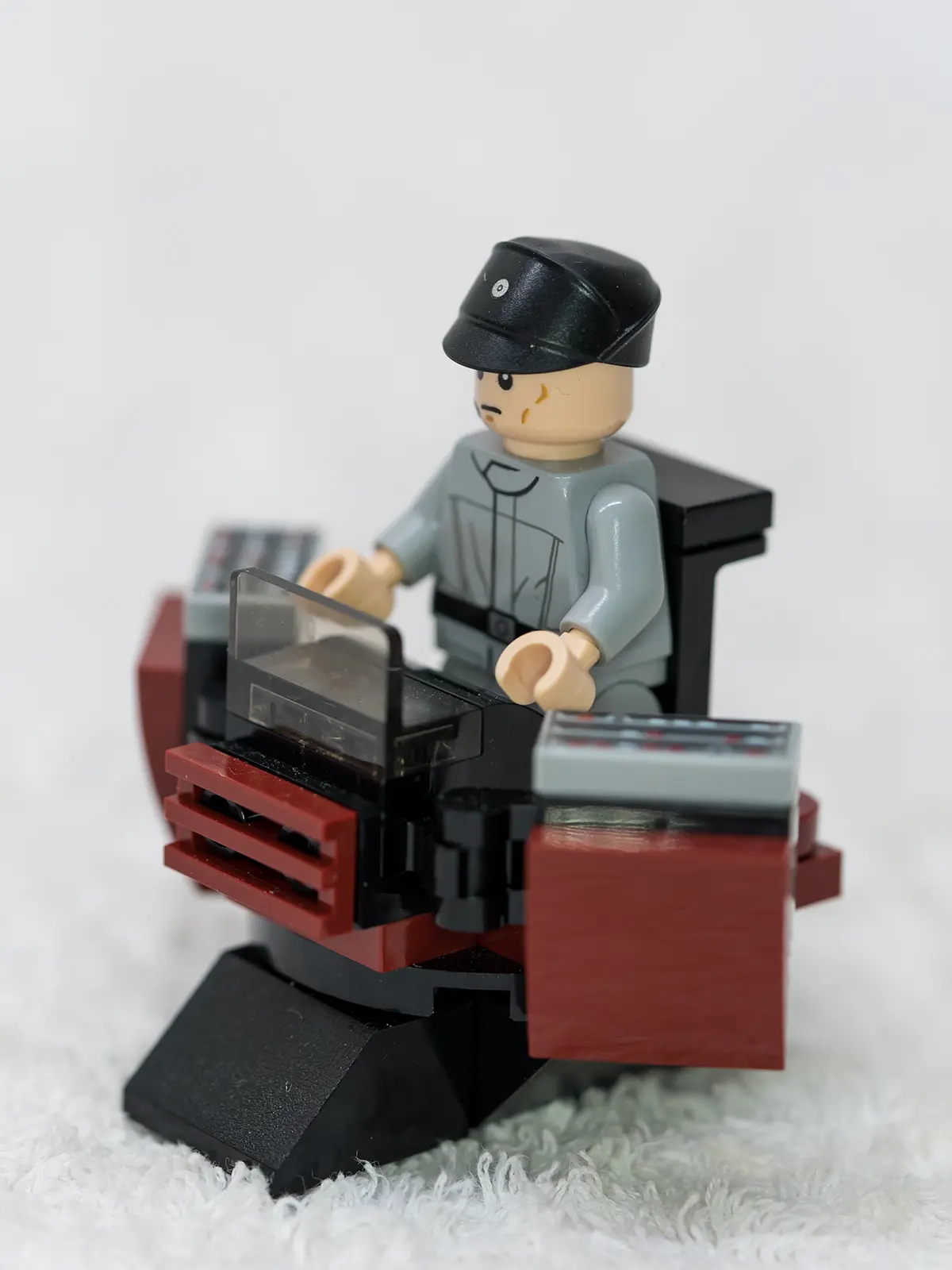 LEGO Stormtrooper minifigures and a mini walker assembled on a desk, ready for battle.