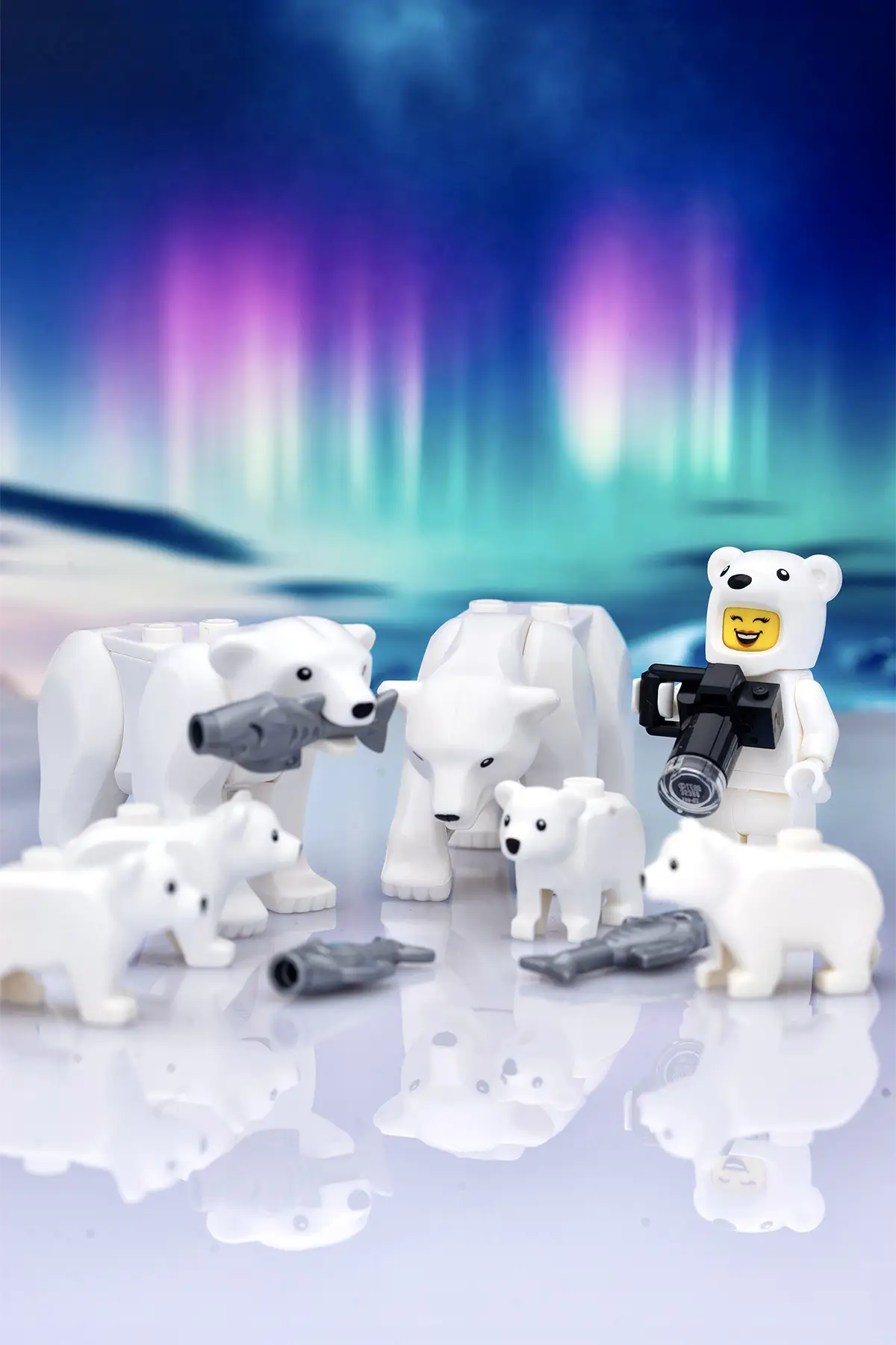 LEGO photographer in a polar bear suit captures a family of polar bears with fish under the northern lights