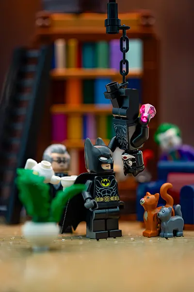 LEGO Batman faces off with a black-suited Catwoman hanging upside down, styled after Tim Burton's 1989 film.