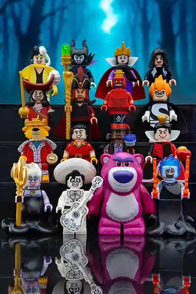 A dramatic lineup of LEGO Disney villains including Maleficent, Ursula, Hades, Cruella de Vil, and the Evil Queen, posed together in a dark, magical setting with swirling green and purple effects.