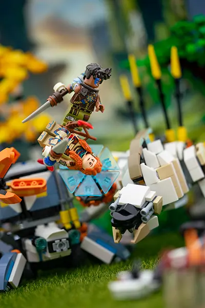 LEGO Aloy and warrior mid-air in battle with mechanical beasts