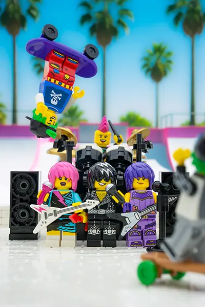 LEGO rock band performs with skateboarders at a sunny skatepark