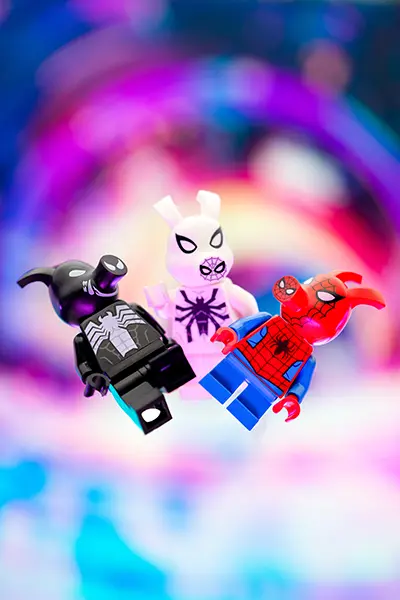 LEGO Spider-Ham, Spider-Bunny, and Venomized Ham figures float in a neon multiverse