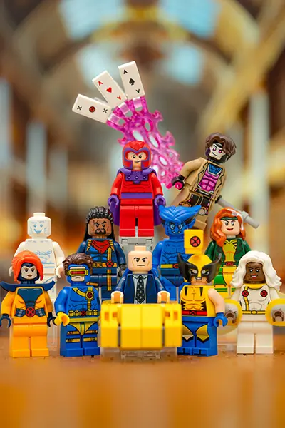 LEGO X-Men minifigures including Wolverine, Cyclops, Storm, and Professor X posed in a team formation
