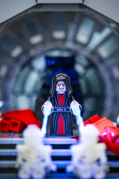 LEGO Emperor Palpatine attacks two minifigures with Force lightning inside the Death Star.