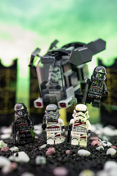 A squad of LEGO Night Troopers stands before their transport ship on eerie terrain under a green sky.