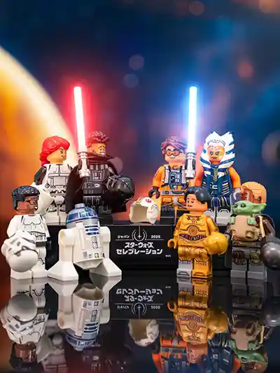A festive LEGO Star Wars scene featuring a diverse group of minifigures from across the saga, gathered in front of a stage with banners and lights celebrating Star Wars Day. Characters from the original trilogy, prequels, sequels, and spin-offs mingle together, with droids, Jedi, Sith, and bounty hunters all joining the party.